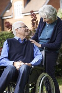 Elderly Couple Using Wheelchair